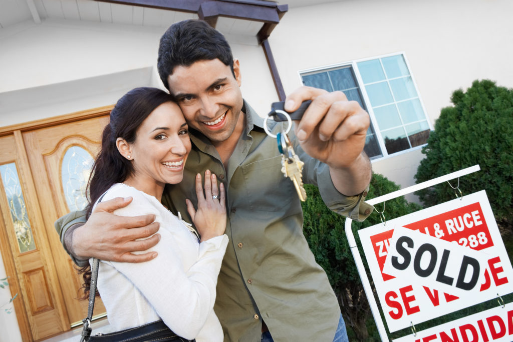 Happy Homeowners with Sign